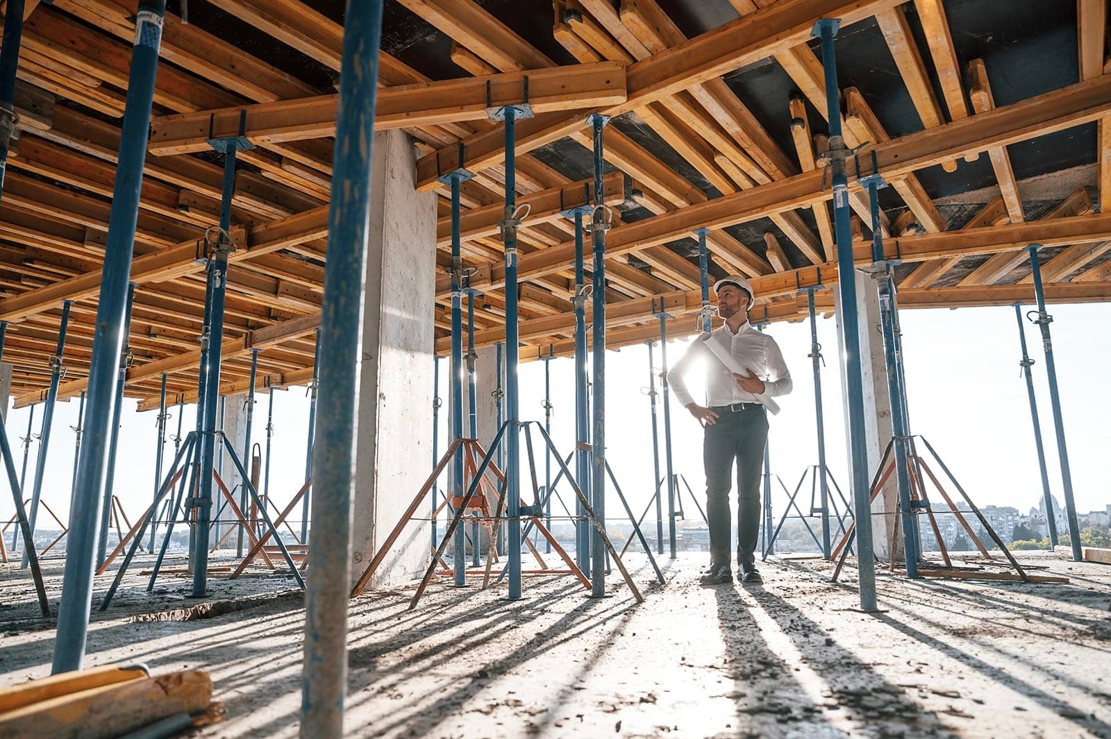 Foreman standing under shored concrete formwork